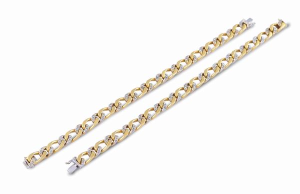 A pair of 18k bicolor gold groumette chain bracelets