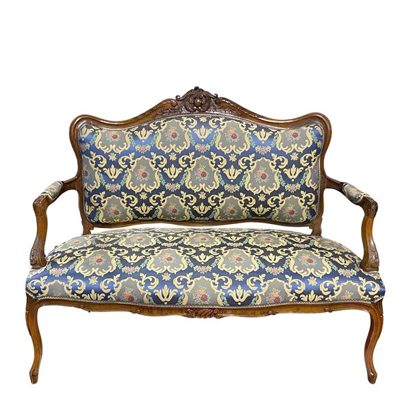 A set of two walnut armchairs and a sofa