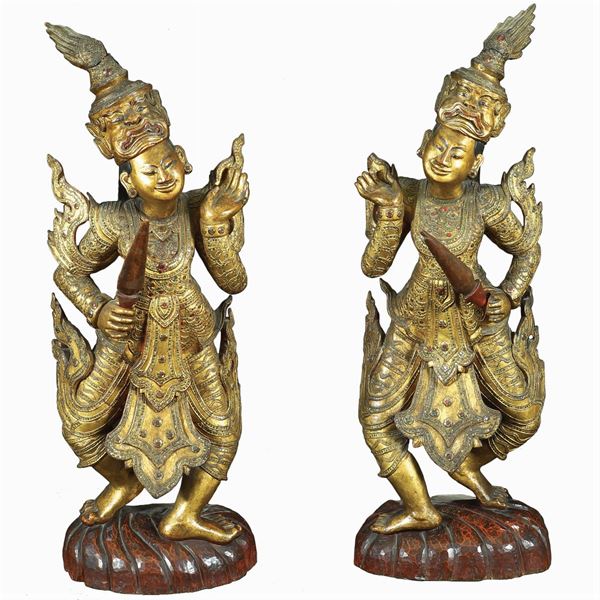 A pair of Oriental giltwood and lacquered sculptures