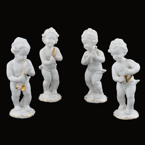 Quattro amorini musicanti in porcellana bianca e oro
