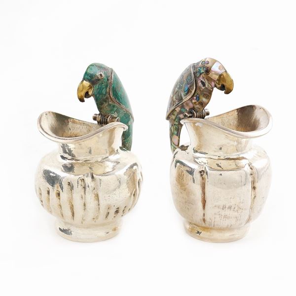A pair of gilt metal milk jugs