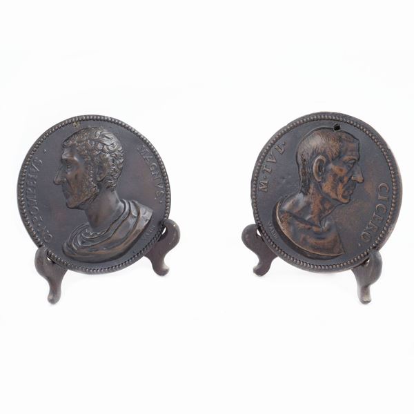 A pair of bronze circular plaques