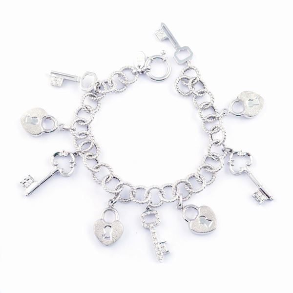 An 18kt white gold charms bracelet with diamonds