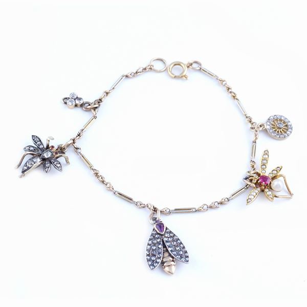 Bracciale charms in oro giallo e bianco