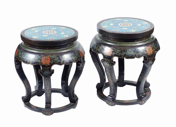 A pair of lacquered wood and enamel stools