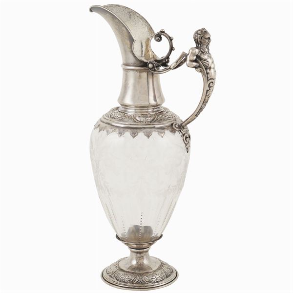 A crystal and silver carafe
