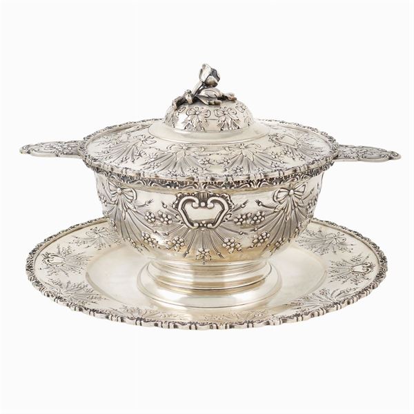 A silver tureen with its tray