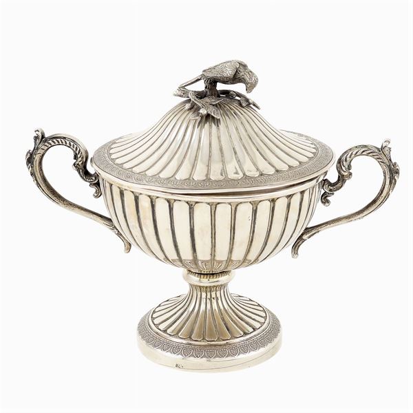 A silver sugar bowl with two handles