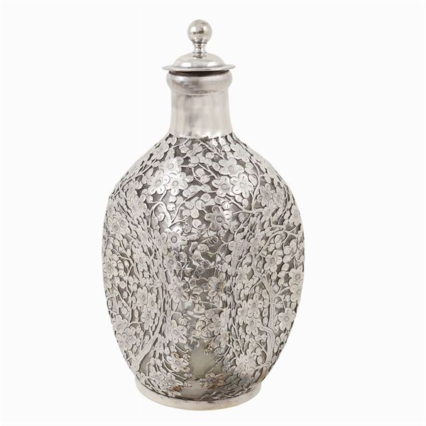 A silver and glass liqueur bottle
