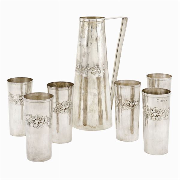 A silver carafe with six glasses