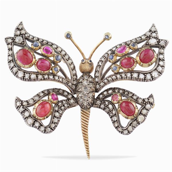 A gold and silver butterfly shaped brooch