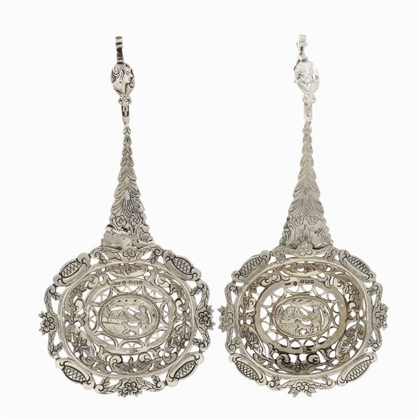 A pair of silver strainers