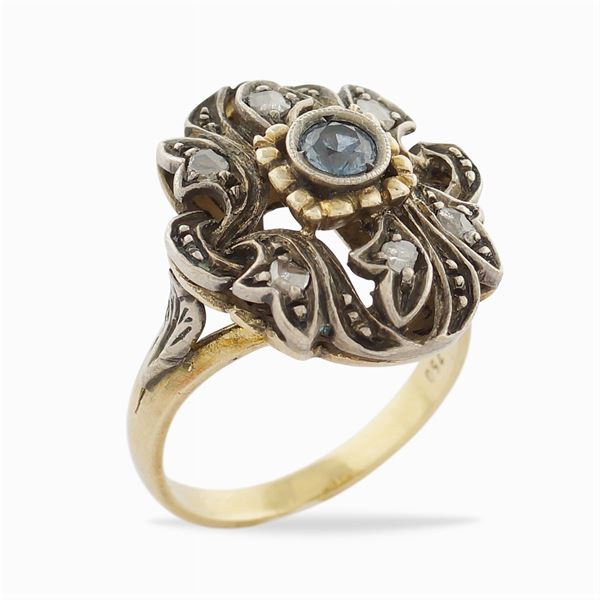 A gold and silver floral shaped ring