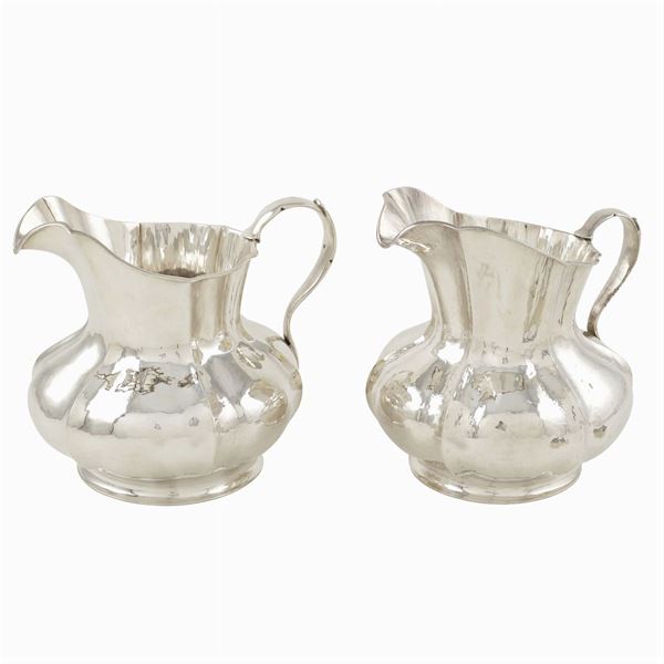 A pair of silver carafes