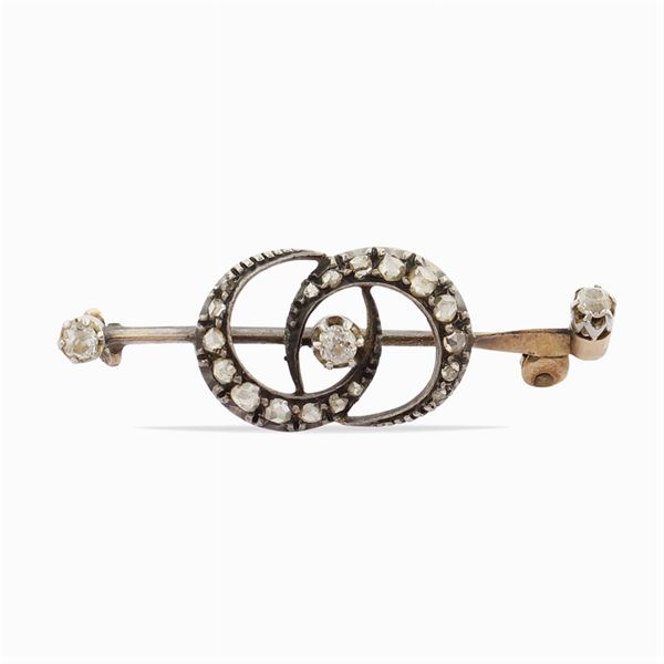 A gold and silver demi lune brooch