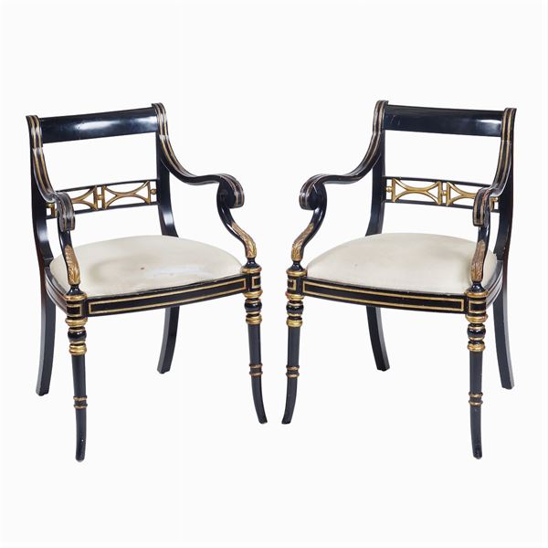 A pair of ebonized and gilt wood armchairs