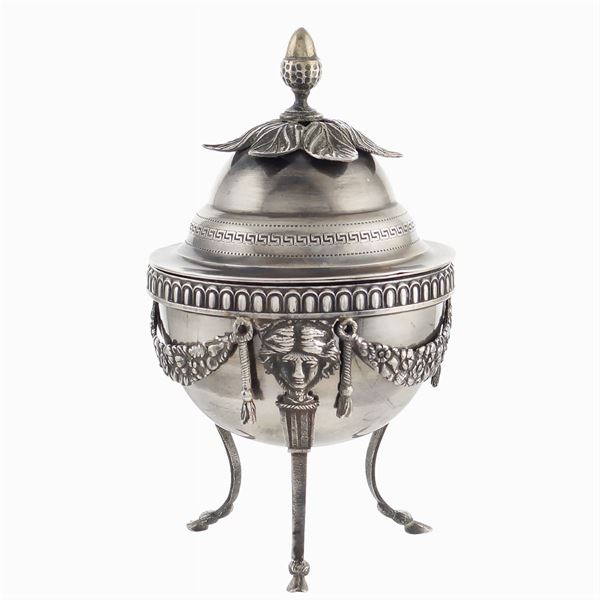 A silver sugar bowl with lid