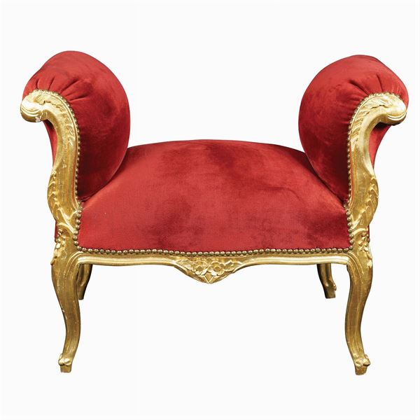 A golden and carved wooded bench