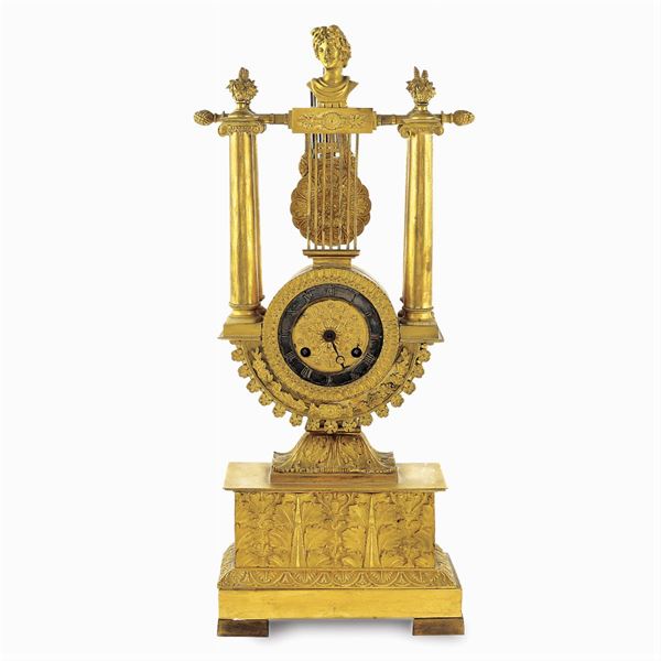 A golden bronze chimney pendulum clock