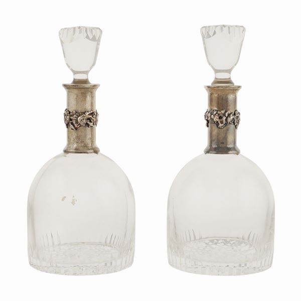 A pair of bottles with crystal cut caps