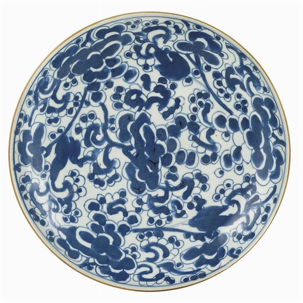 A white and blue porcelain soup plate