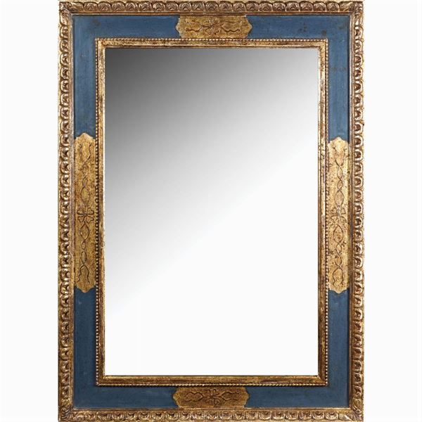 A rectangular wooden wall mirror