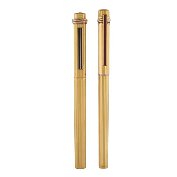 Must de Cartier, two gilt coated vintage pens