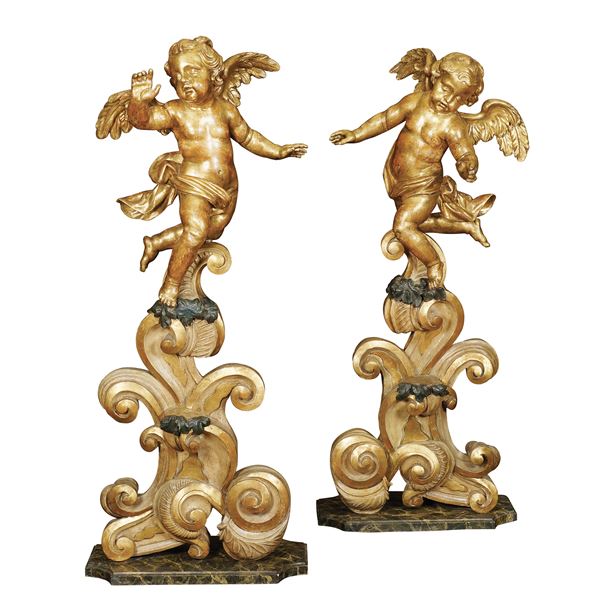 A pair of golden wood sculptures