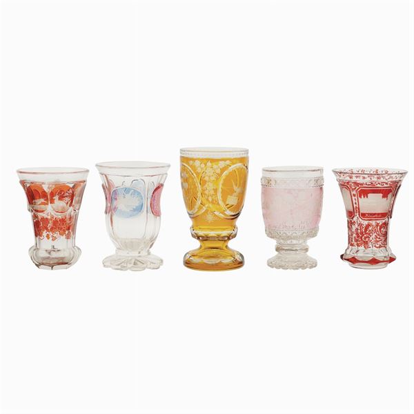 A collection of five colored crystal glasses