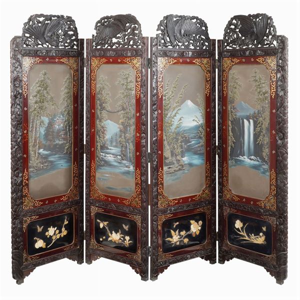 A large carved and laquered wood screen