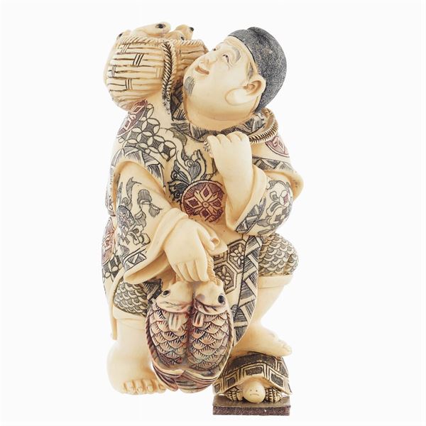 A figure in bone partially painted in polychrome