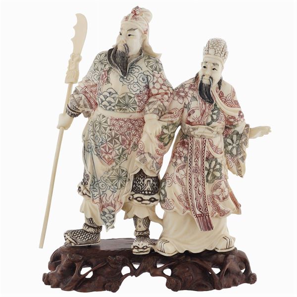 A group of figures in bone partially painted in polychromy