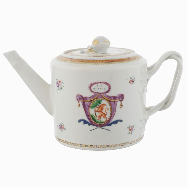 A porcelain teapot painted in polychromy on a white background