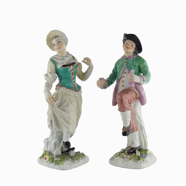 A pair of polychrome porcelain figures
