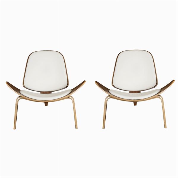 A pair of design armchairs