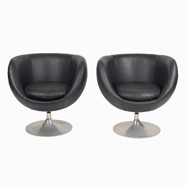 A pair of vintage eco-friendly leather revolving armchairs