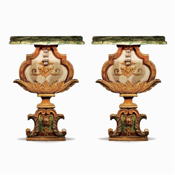 A pair of lacquered and giltwood consoles
