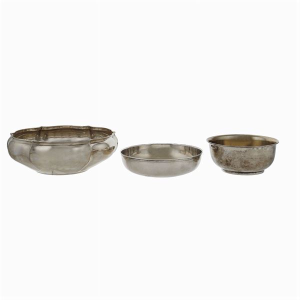 Three circular silver bowls