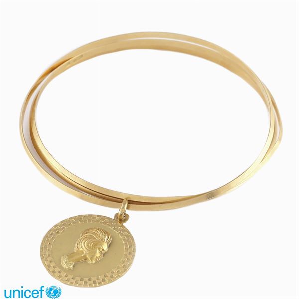 Tre bracciali a manetta in oro giallo 18kt