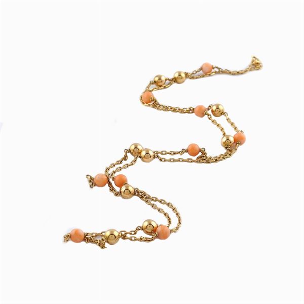 An 18kt gold necklace with pink coral spheres