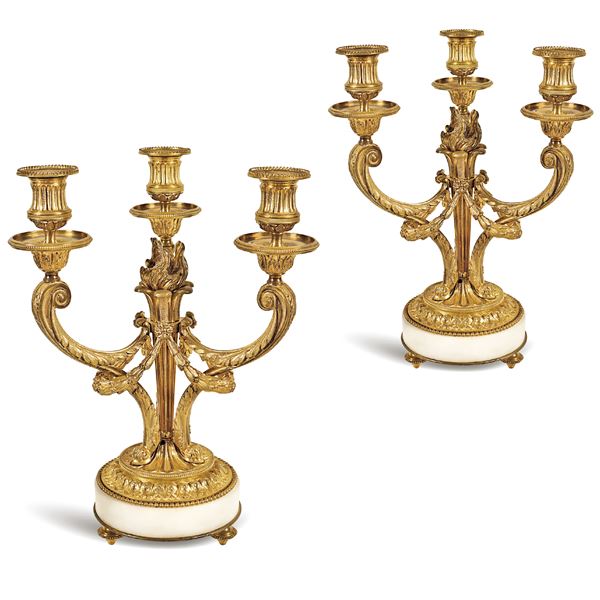 A pair of gilt bronze three arm candelabras