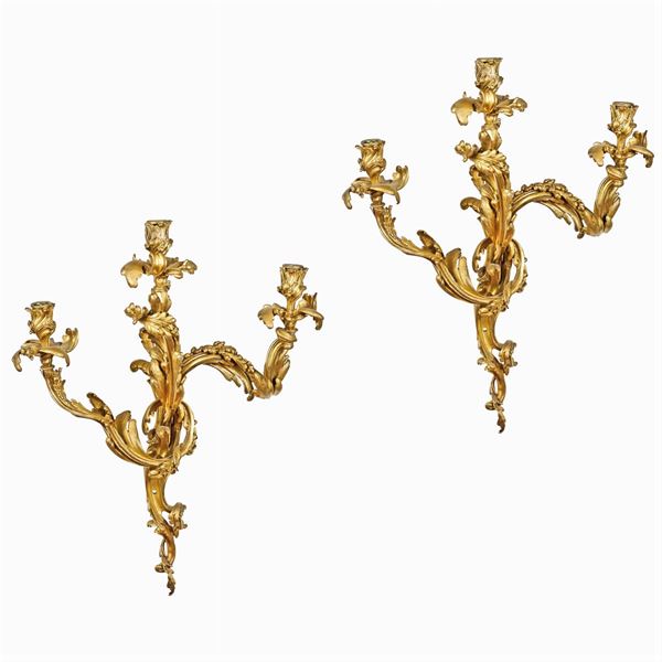 Coppia di appliques in bronzo dorato a tre luci