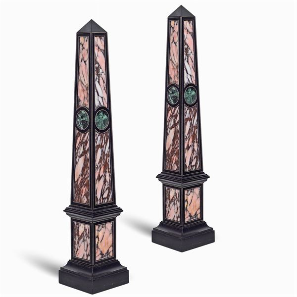 a pair of marble and wood obelisks