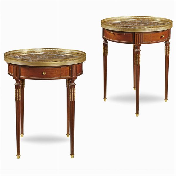 A pair of mahogany and marble gueridons