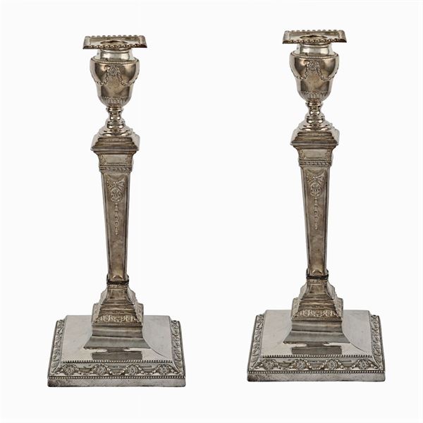 A pair of silver metal candlesticks