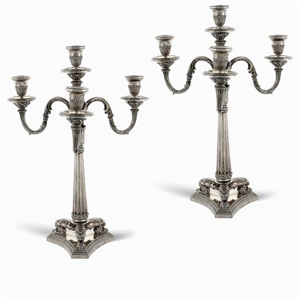 A pair of silver four lights candelabra