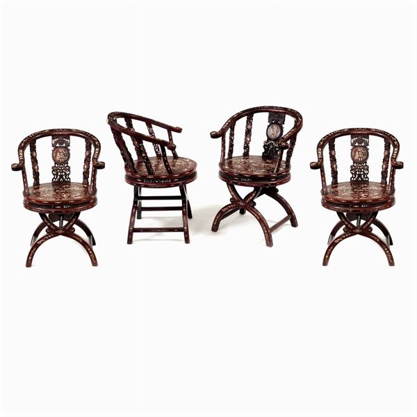 Four teak armchairs
