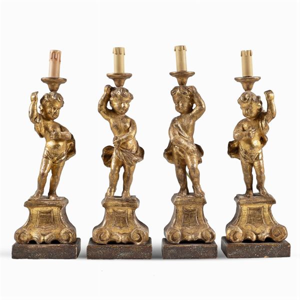 Quattro sculture in legno dorato