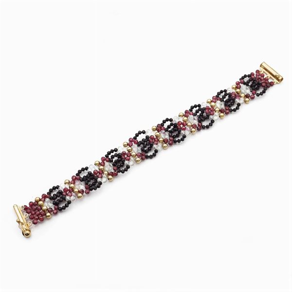 Bracciale in oro giallo 18kt, cristallo di rocca, onice nero e granati