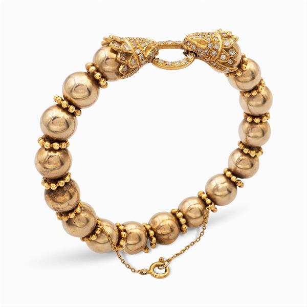 Bracciale a manetta in oro giallo 18kt e diamanti